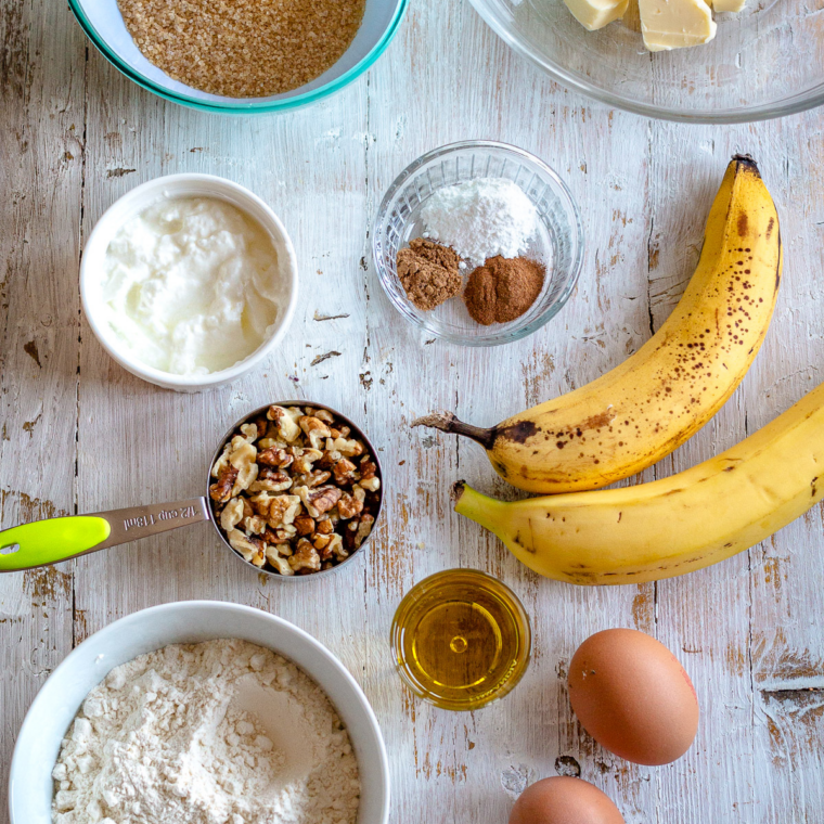 Ingredients needed for Air Fryer Chocolate Chip Banana Bread on kitchen table.