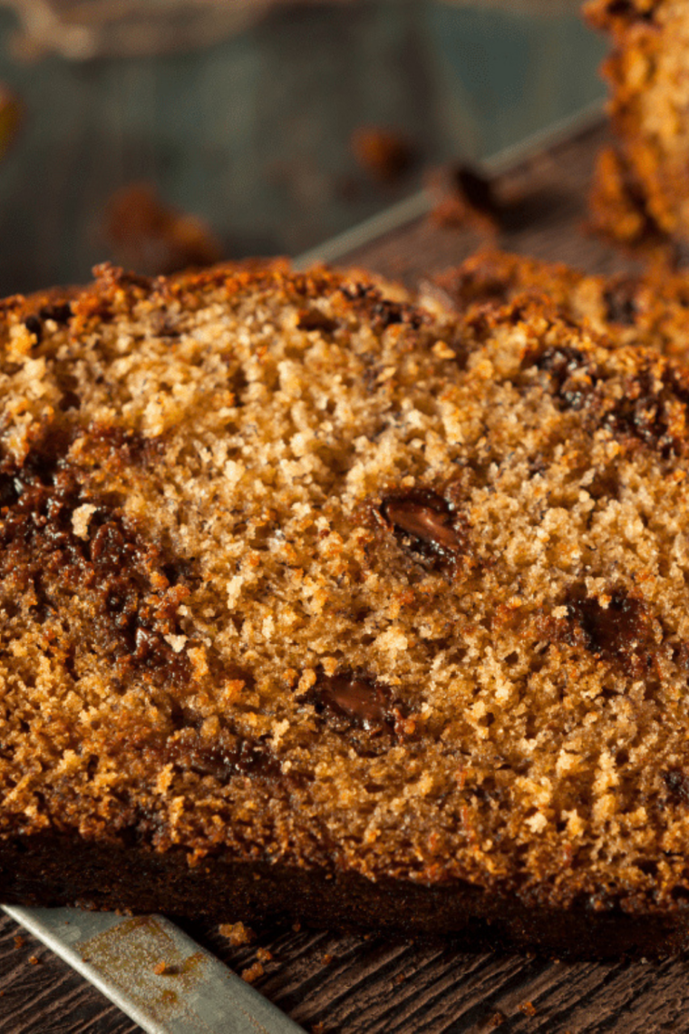 Moist air fryer chocolate chip banana bread sliced on a wooden board