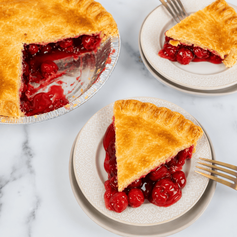 Slice of air fryer cherry pie on a plate with a flaky golden crust and sweet cherry filling