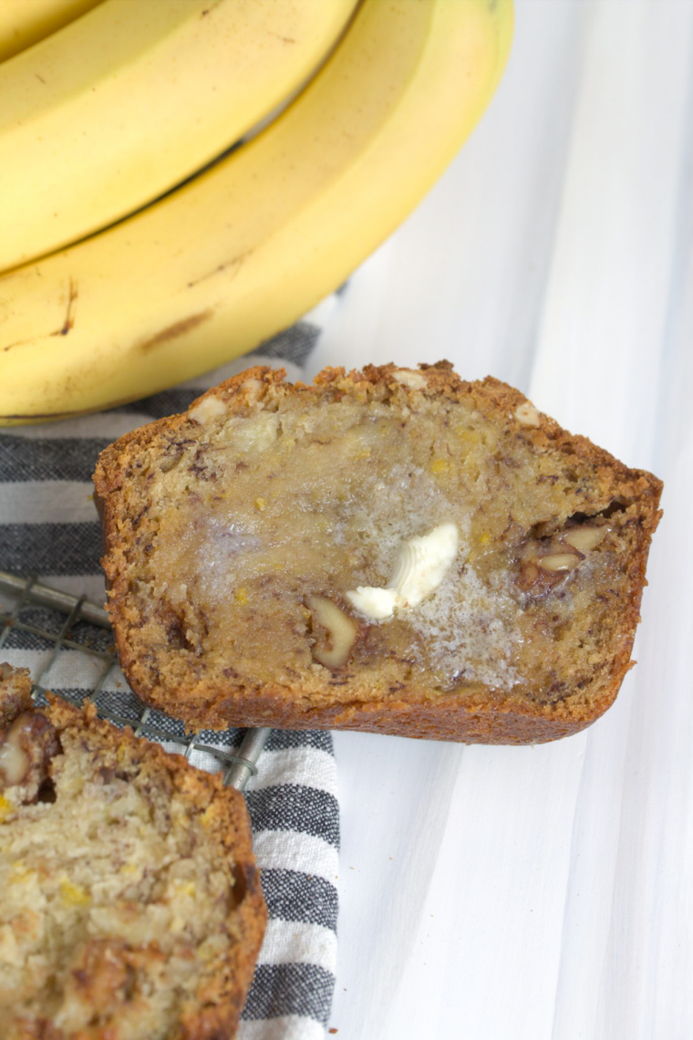 Sliced Kona Inn banana bread on wooden board, soft and moist