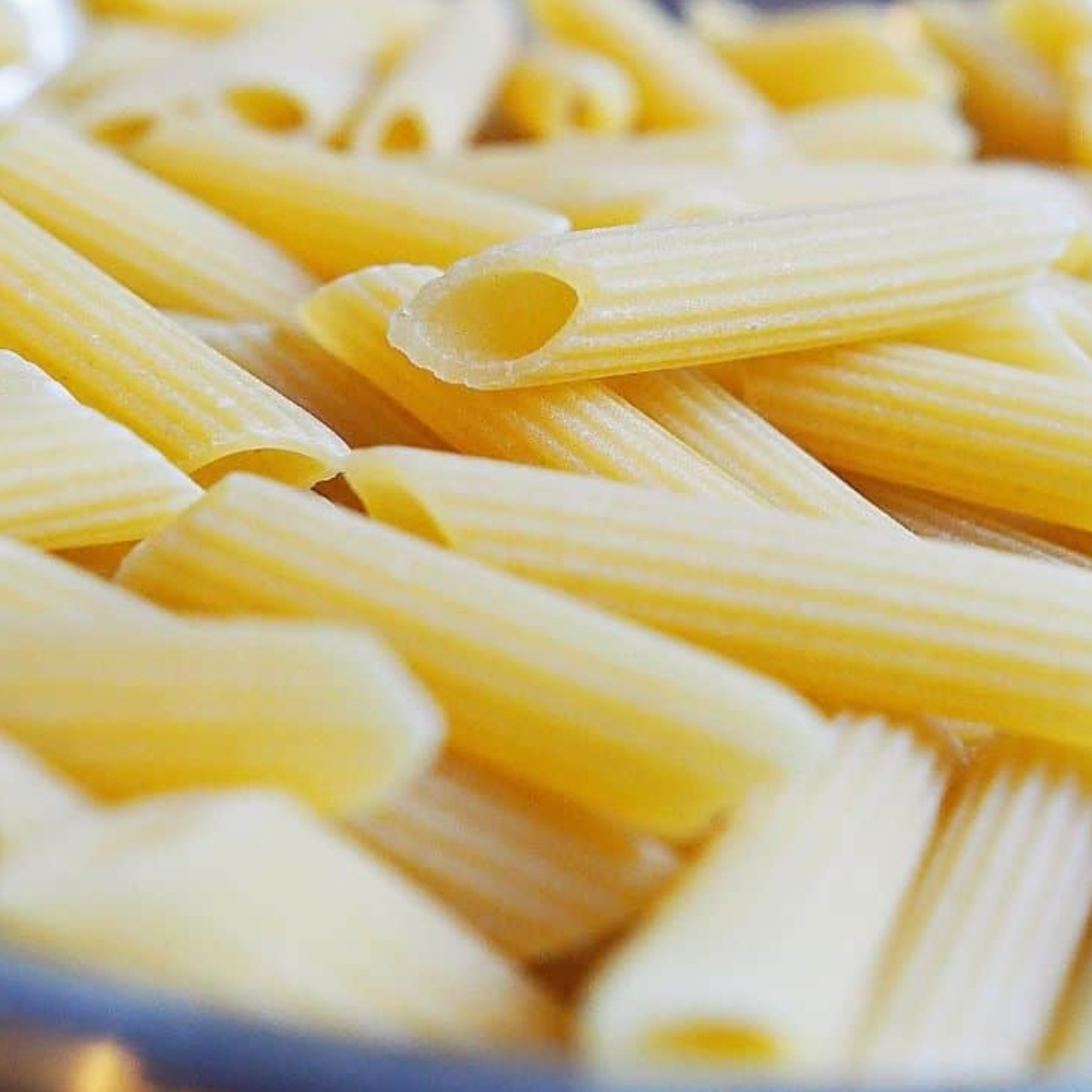 Ingredients needed for Instant Pot Penne with Sausage and Broccoli Rabe on table.