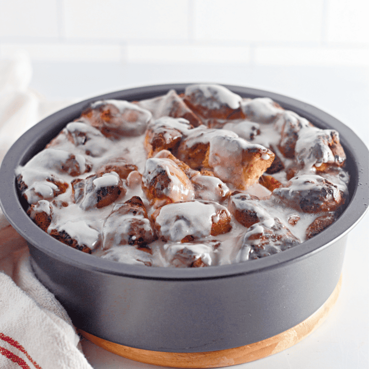 "Air Fryer Cinnamon Roll French Toast stacked high, garnished with powdered sugar."