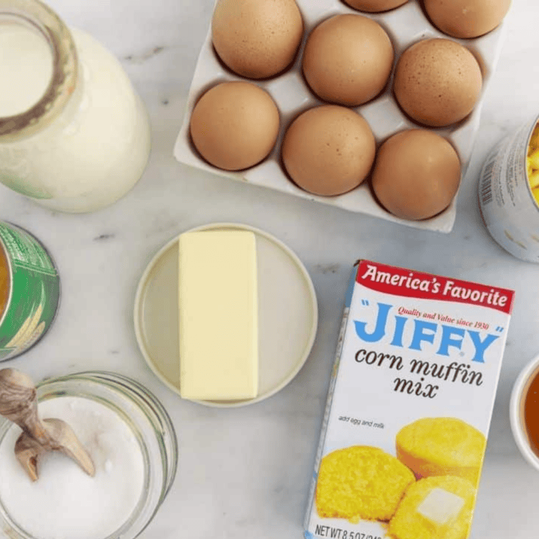 Ingredients for air fryer corn casserole: Jiffy mix, creamed corn, whole corn, eggs, butter, heavy cream, honey, and sugar