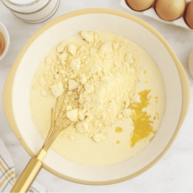 Stirring creamed corn, drained whole corn, and Jiffy mix into the corn casserole batter