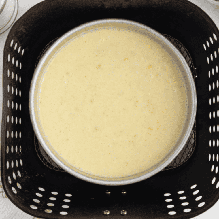 Pouring corn casserole batter into a foil-covered pan to air fry at 320°F until set