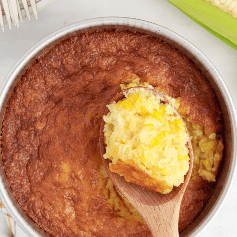 Finished air fryer corn casserole with a golden, crispy top in a baking dish