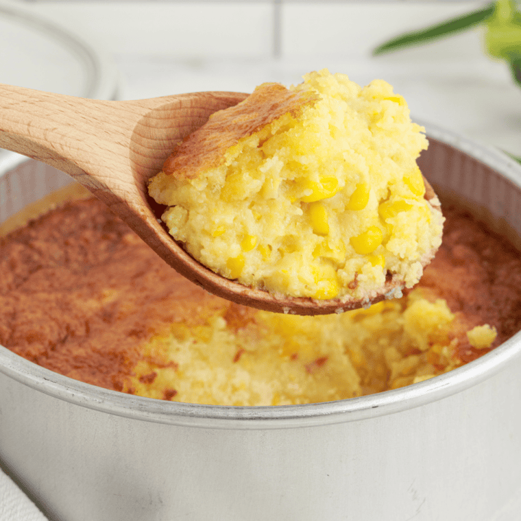 A scoop of creamy air fryer corn casserole served as a side dish