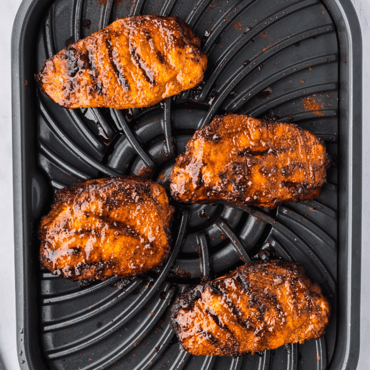 Placing seasoned pork chops in the air fryer basket and cooking at 400°F for 12-15 minutes.