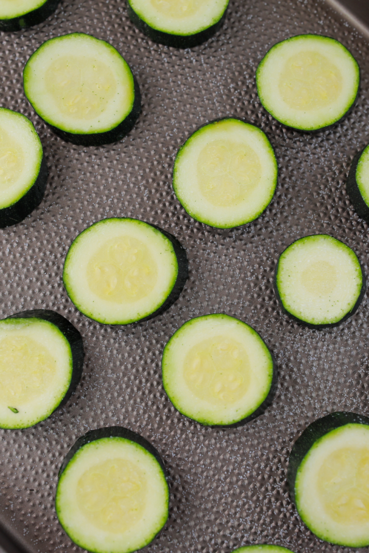 Salting zucchini slices and letting them rest to draw out moisture before rinsing