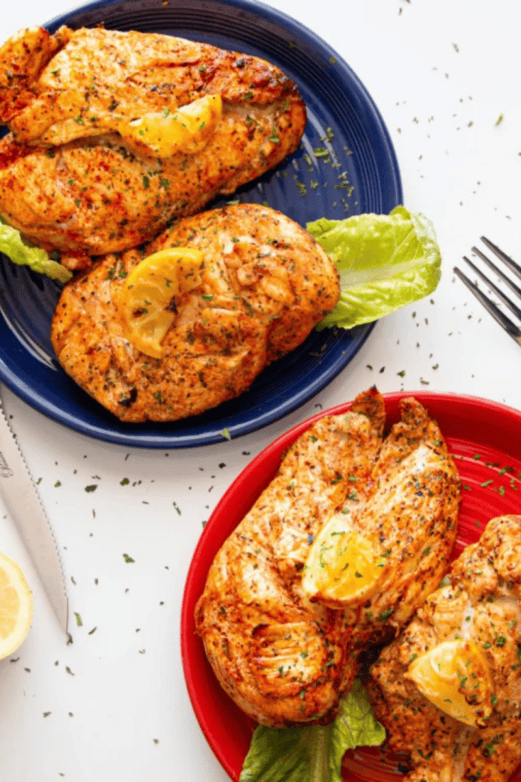 Air fryer lemon pepper chicken served on a plate, garnished with lemon and ready in 30 minutes