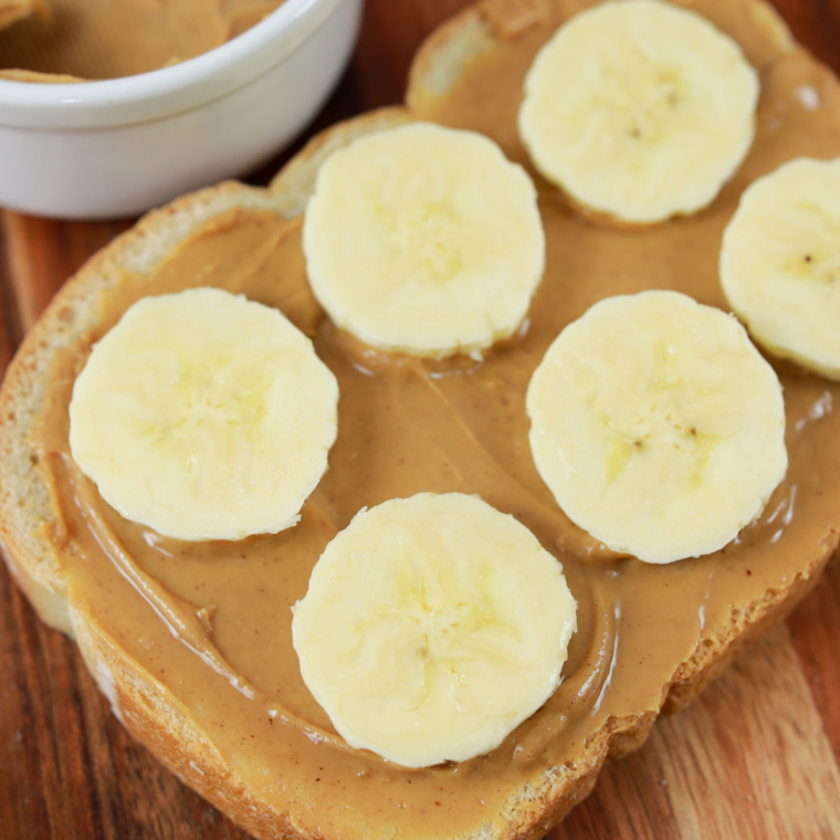 Close-up of toasted bread with peanut butter and caramelized banana slices in air fryer basket