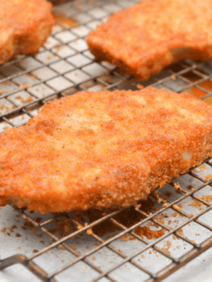 Crispy BBQ glazed Shake and Bake chicken on a baking sheet with golden breadcrumb coating and glossy barbecue glaze.