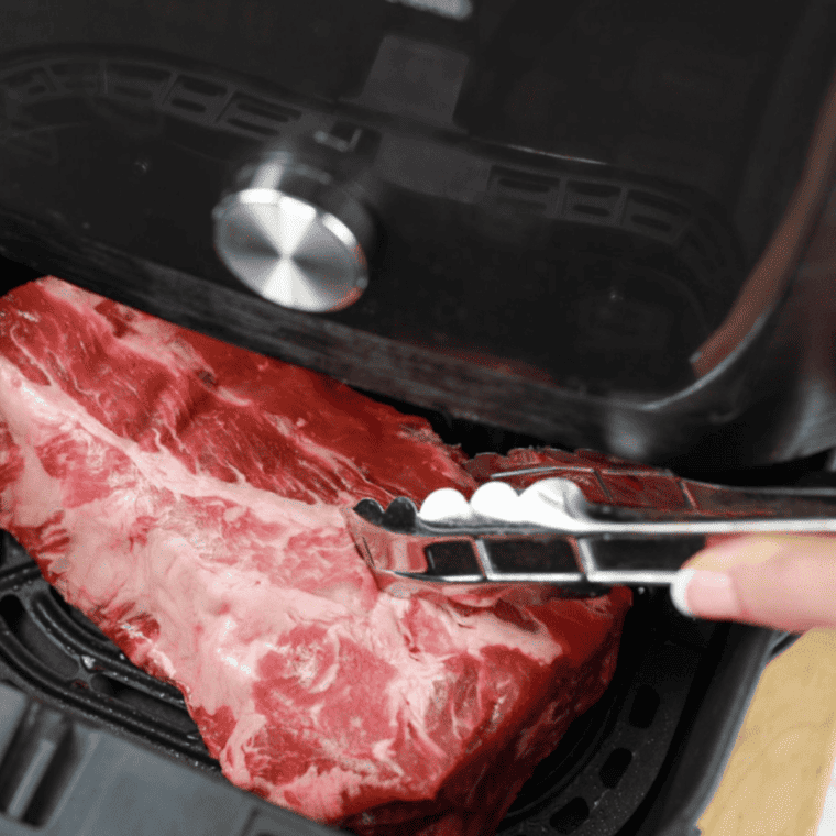 Uncooked ribs placed into the air fryer basket.