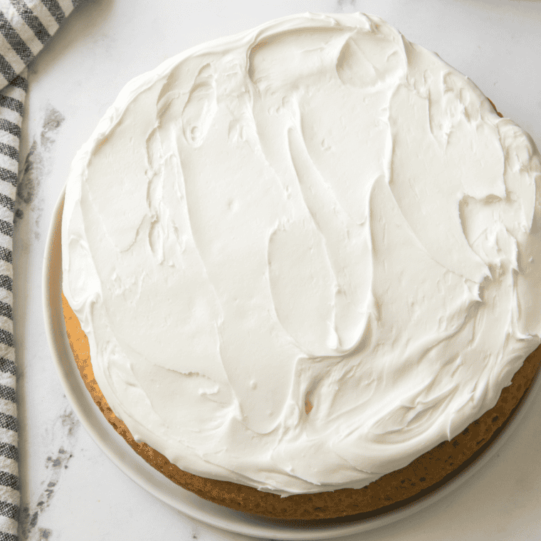 Slice of frosted lemon ricotta cake showing fluffy interior crumb