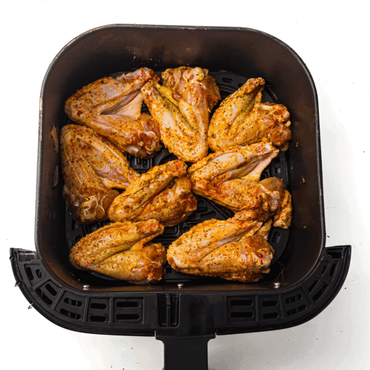 Place lemon dijon chicken wings into the air fryer basket.