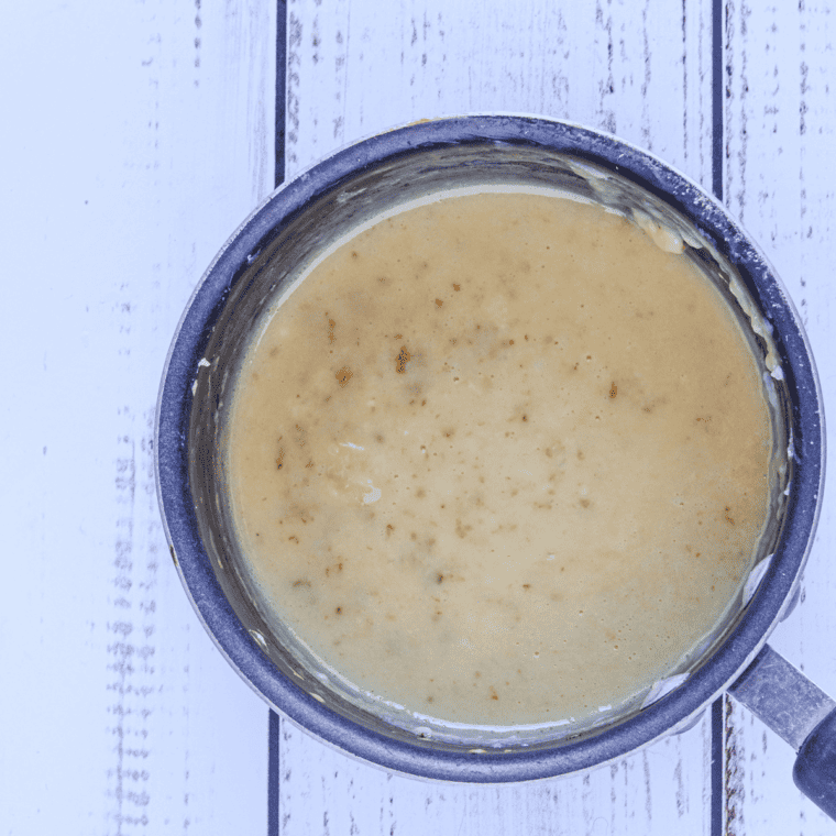 Whisking eggs and gradually combining with hot custard mixture in a small saucepan to make thick, creamy pastry cream.