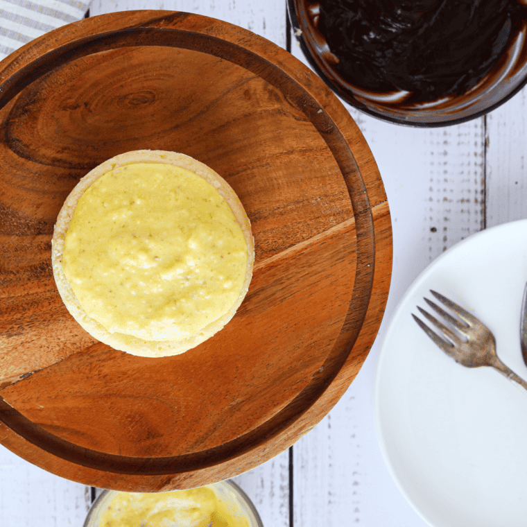 Hot heavy cream being combined with chocolate chips to make a smooth chocolate ganache.