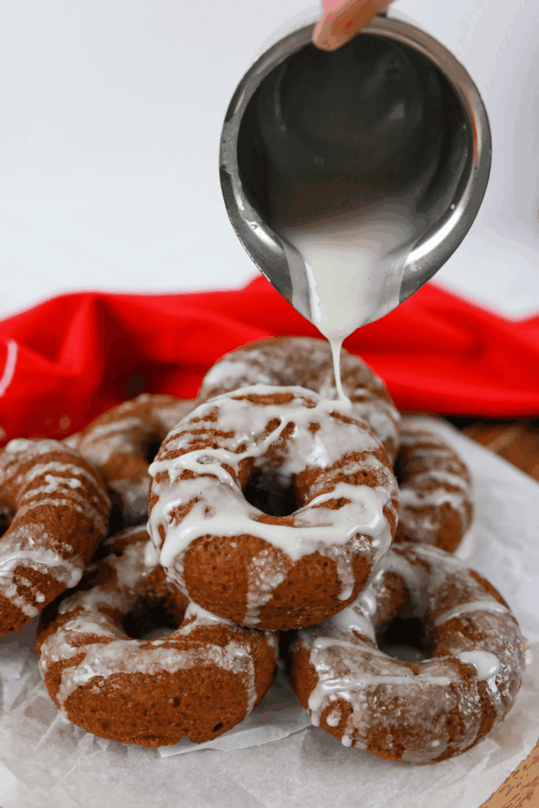 Plate of air fryer gingerbread donuts with spiced glaze and holiday vibes