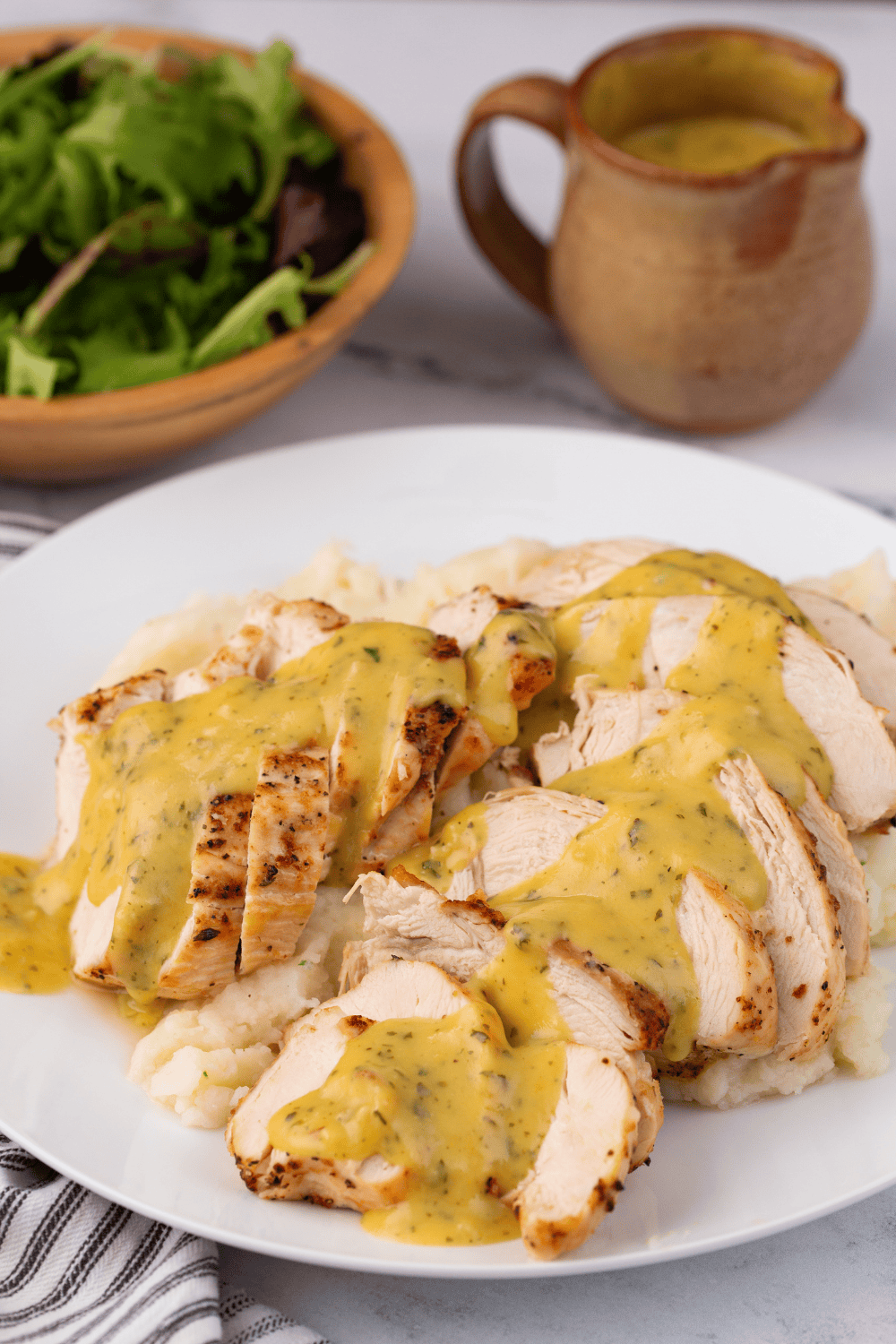 Cooked buttermilk chicken breast sliced to show the juicy interior