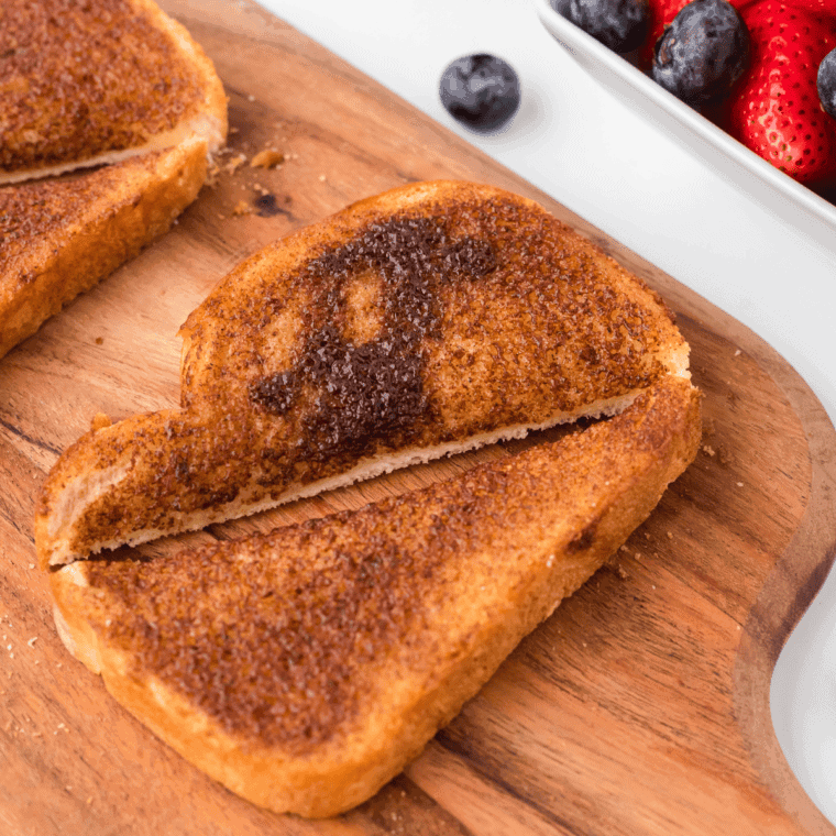 Air fryer cinnamon toast cut in half on a cutting board