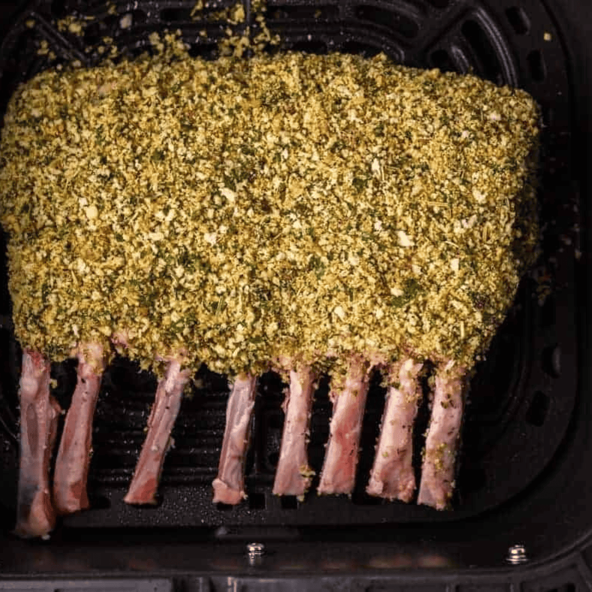 Air-fried rack of lamb cooked to perfection, seasoned with herbs and spices, ready to serve as a delicious main dish.