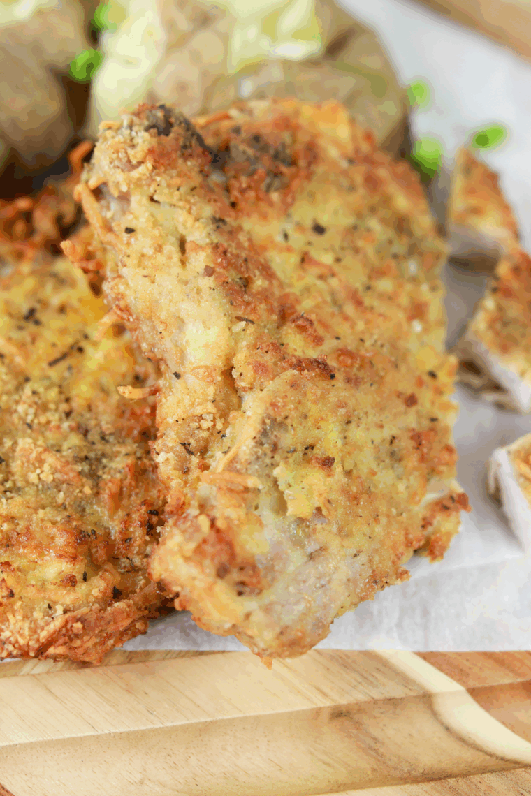 Air fryer Applebee’s style Parmesan crusted pork chops, golden and crispy, served on a plate with garnish.