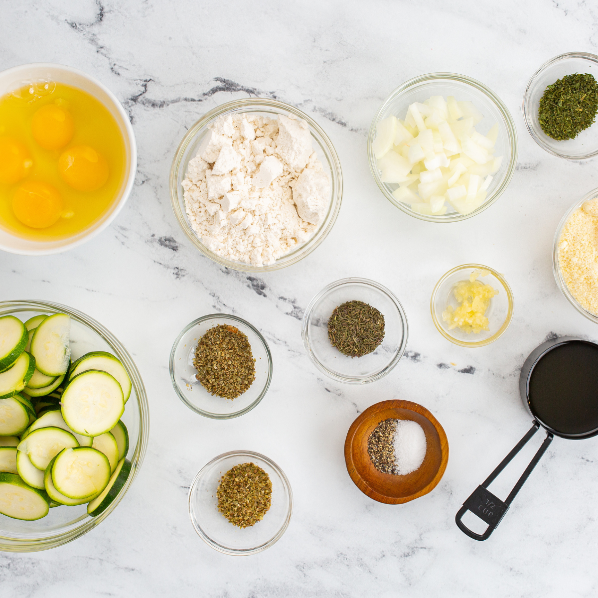 Ingredients needed for Air Fryer Zucchini Casserole on kitchen table.