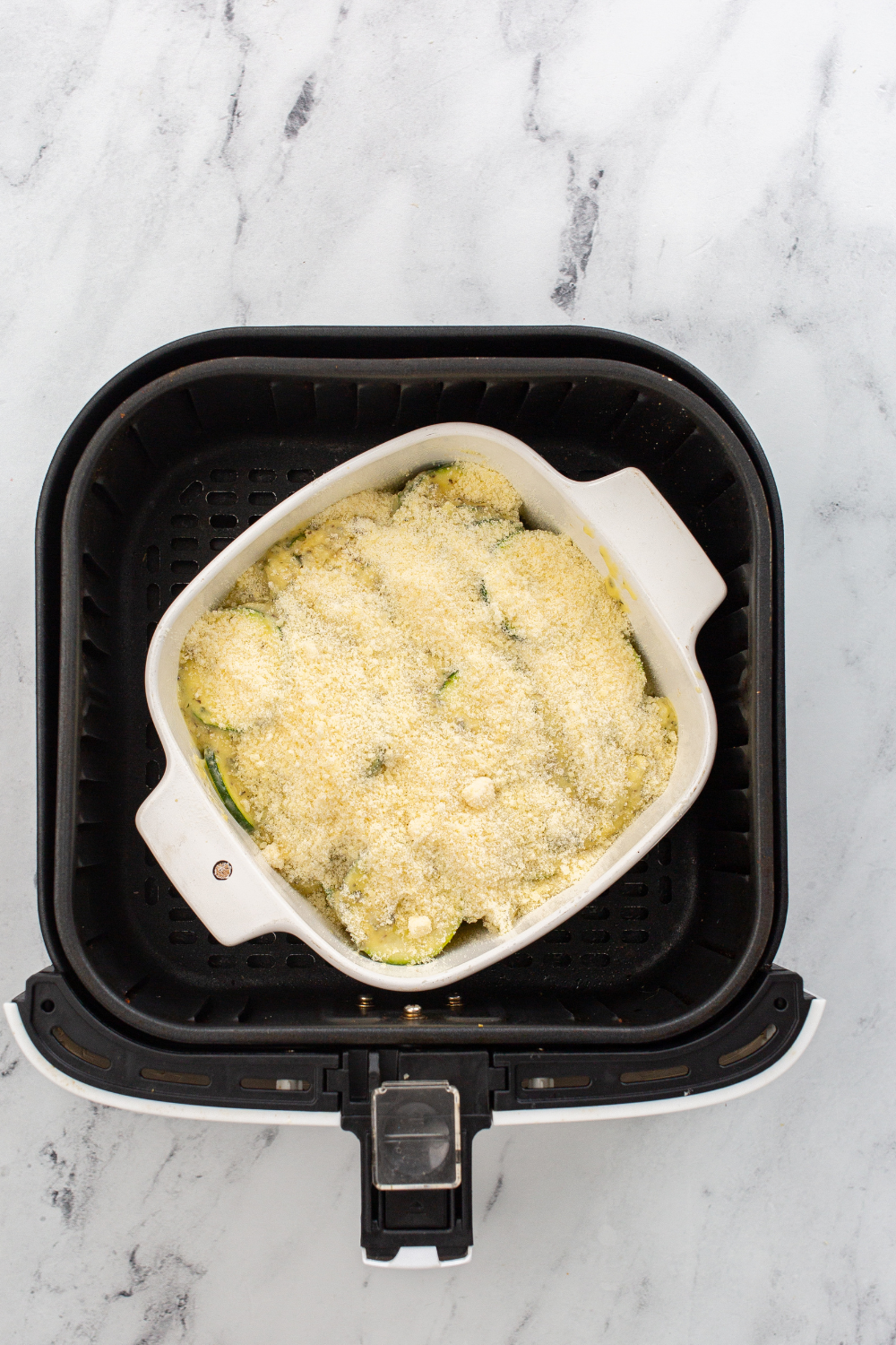 Air Fryer Zucchini Casserole with cheese, zucchini, and spices, cooked to perfection in an air fryer.