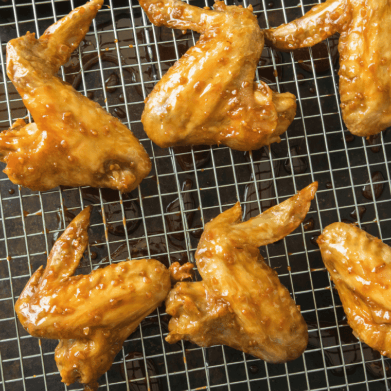 Plate of crispy air fryer chicken wings with dipping sauce on the side