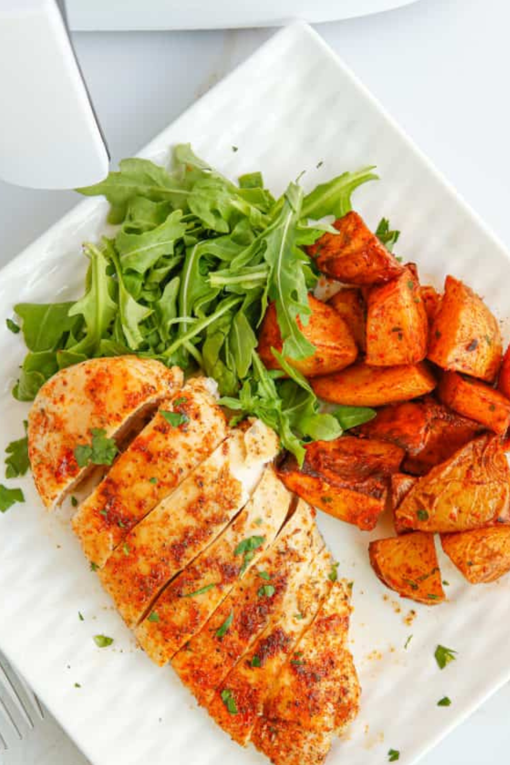 Delicious Texas Roadhouse Herb Crusted Chicken served on a plate, showcasing the golden herb crust and garnished with fresh herbs.