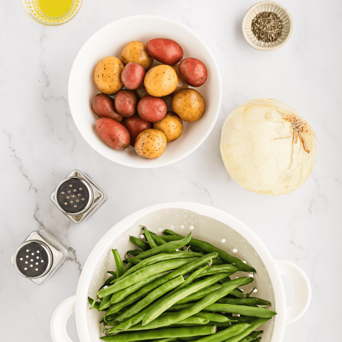 Ingredients needed for Air Fryer Green Beans and Potatoes Recipe on kitchen table.