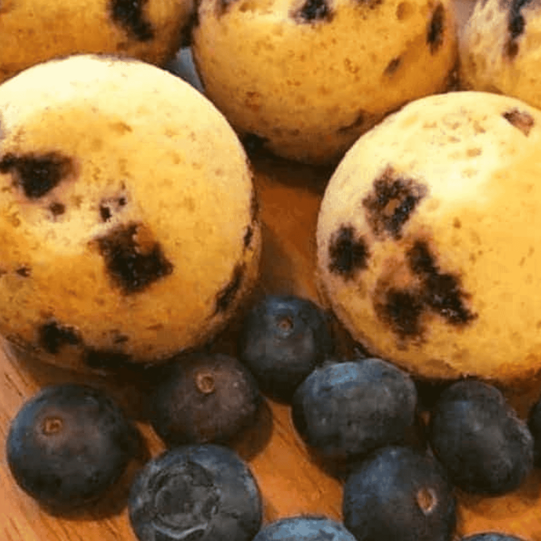 Flipping air fryer blueberry muffins out of silicone cups, ready to serve with melted butter