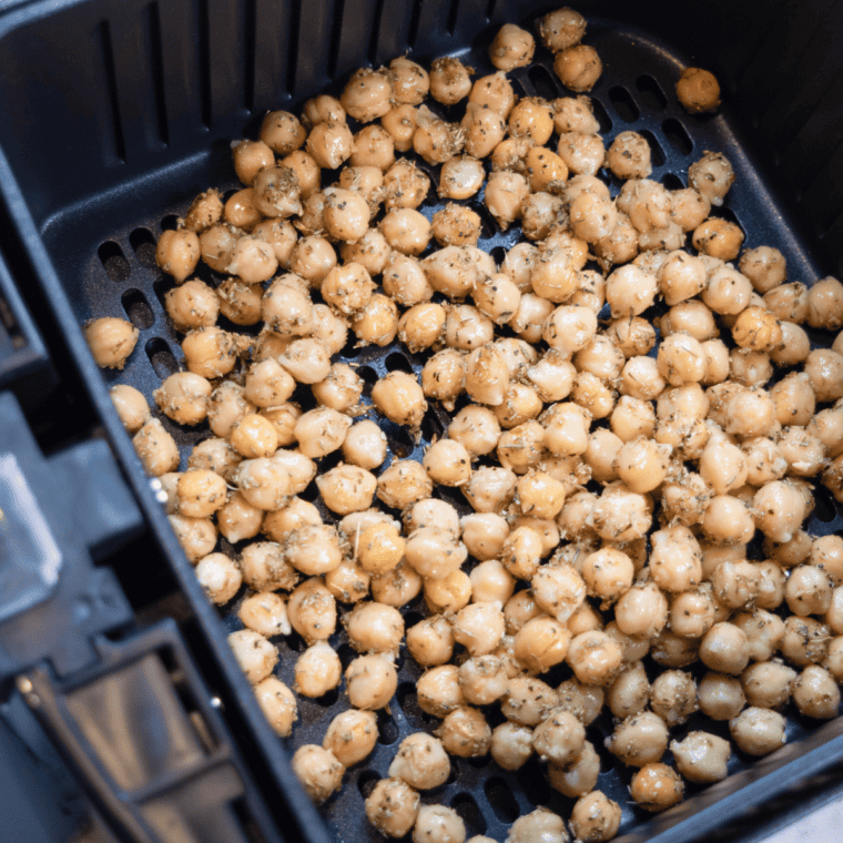 Place the seasoned chickpeas into the air fryer basket.