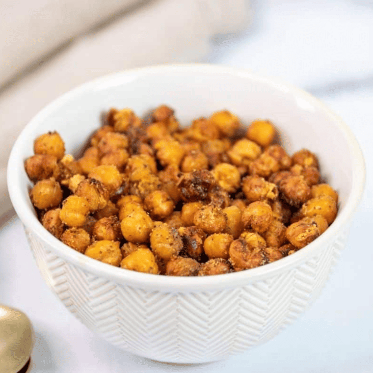 Golden, crispy roasted chickpeas seasoned with garlic and herbs in a bowl, ready to eat.