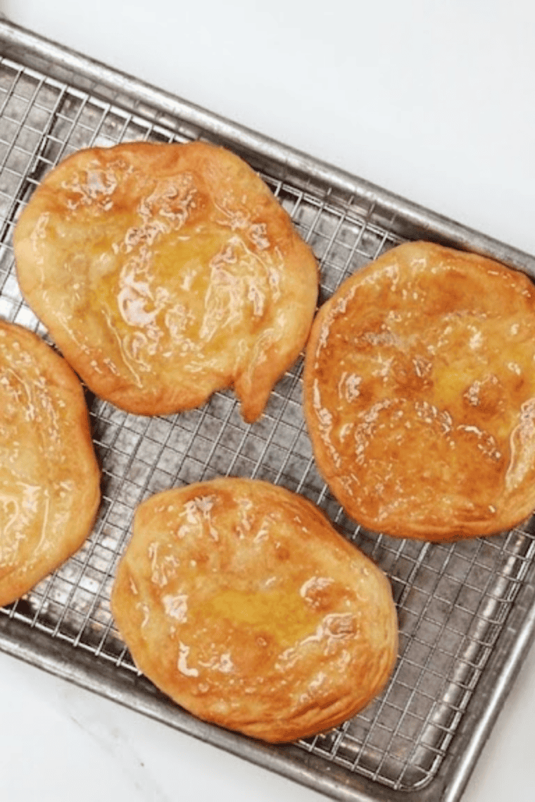 Homemade Navajo fry bread cooking in an air fryer basket until puffed and golden brown.