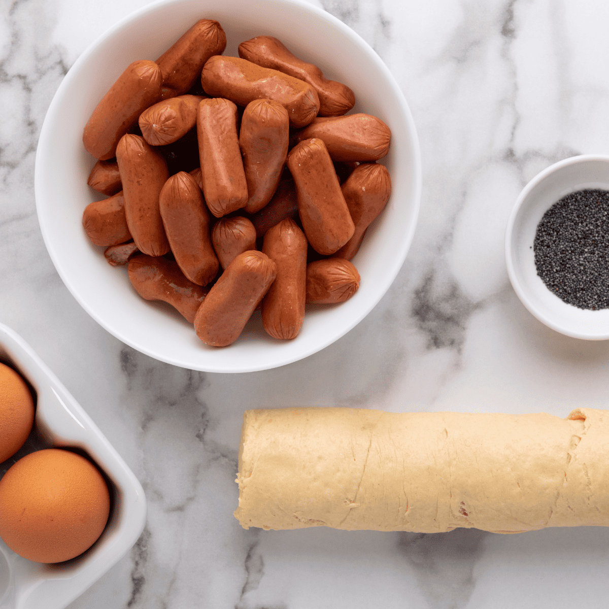 Ingredients needed for Air Fryer Pigs In A Blanket on kitchen table. Close-up.