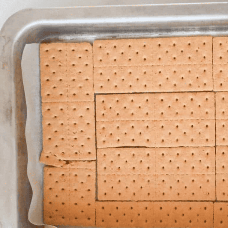 Graham crackers arranged over brownie batter in a greased pan