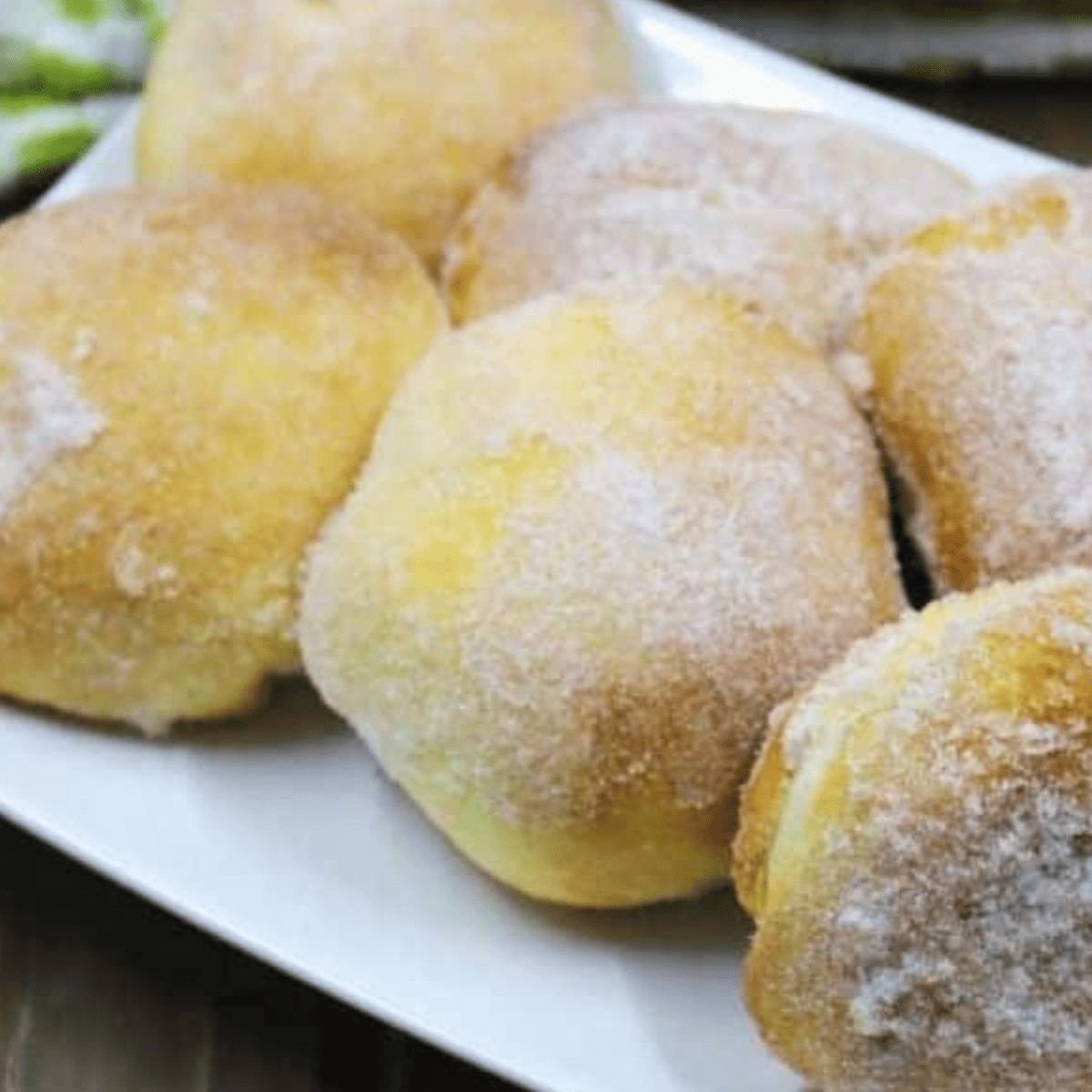 Close-up of a cinnamon sugar apple stuffed donut cut open to show the apple filling