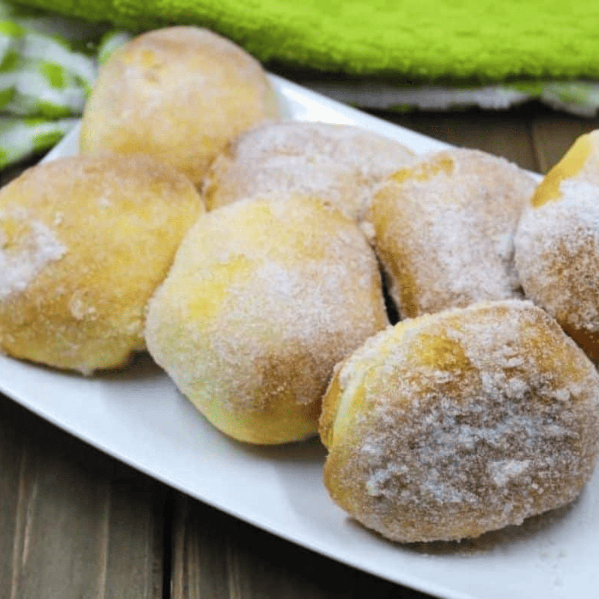 Air fryer apple stuffed donuts coated in cinnamon sugar, stacked on a plate