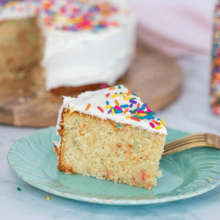 Slice of air fryer birthday cake showing moist, fluffy confetti crumb on a plate
