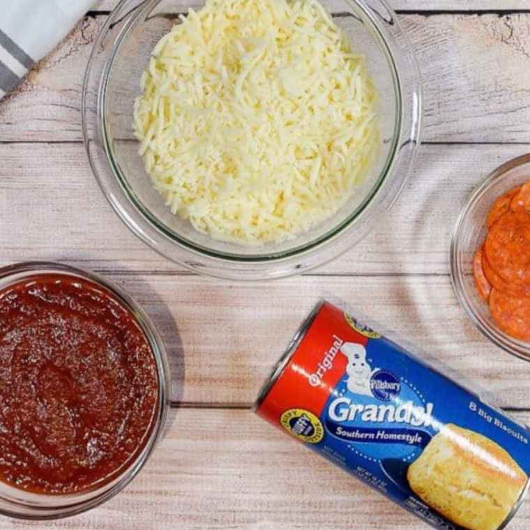 Ingredients for air fryer pepperoni pizza casserole on a wooden table.