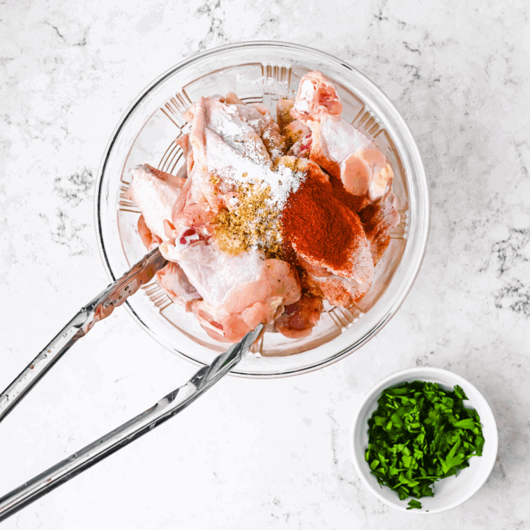 Toss chicken wings in a large mixing bowl with seasonings.