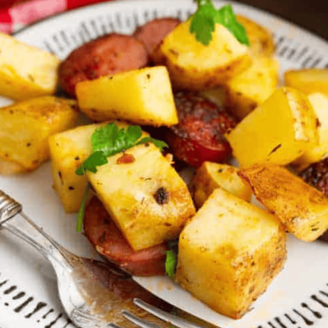 Crispy air fryer kielbasa and potatoes served in a white bowl
