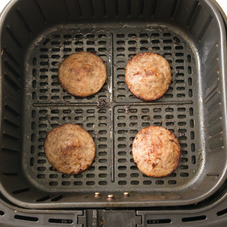 Breakfast sausage browning and crumbled in a skillet for air fryer sausage biscuits
