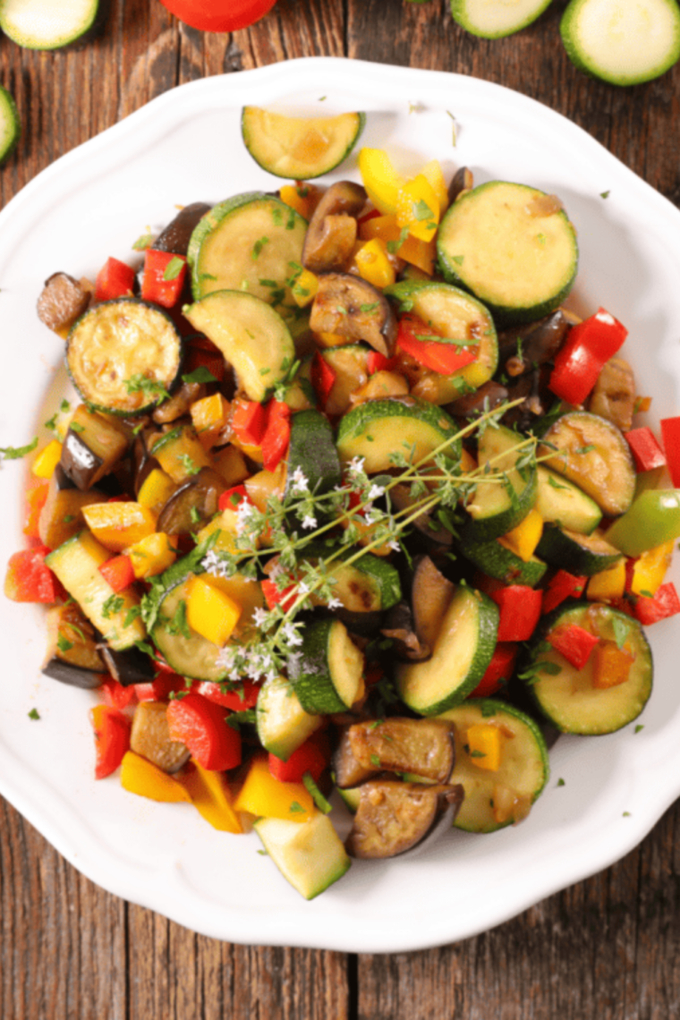 Air fryer yellow squash and zucchini slices cooked until crispy and lightly browned on tray