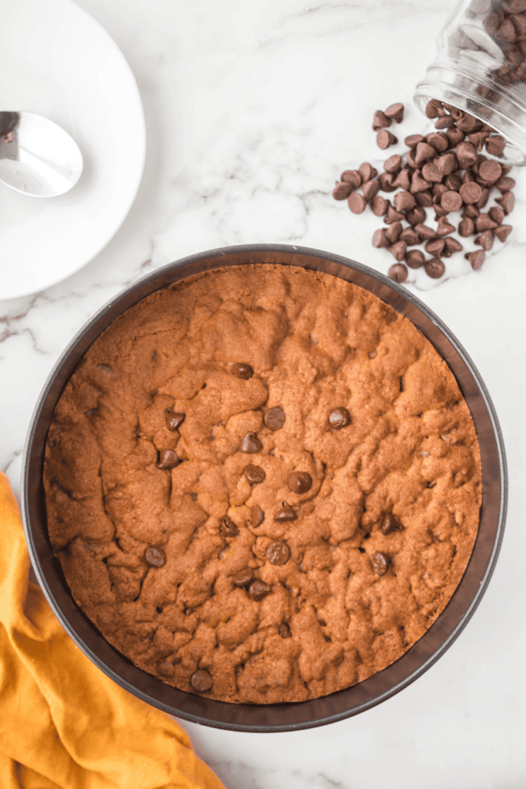 Skillet cookie baking in the air fryer at 320°F until edges are golden and center is set.