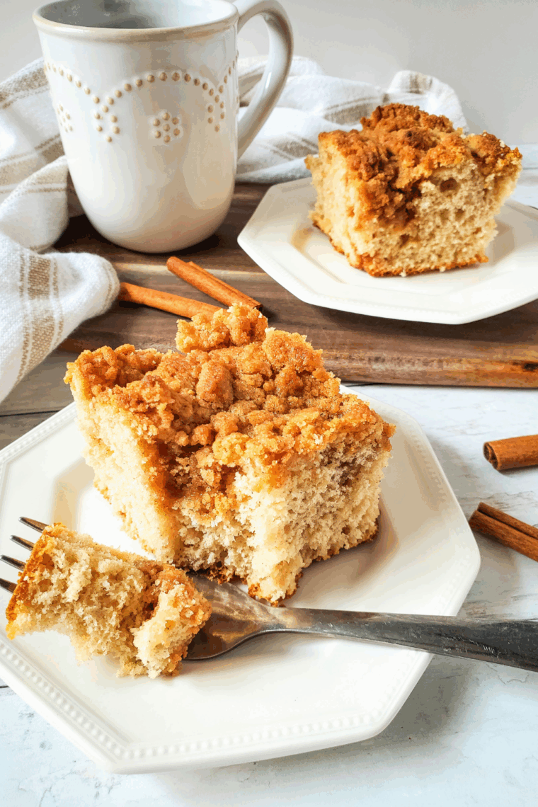 Easy yellow cake mix coffee cake with cinnamon-sugar topping on a serving plate.