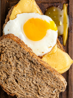 Ninja Crispi fried eggs with crispy lacy brown edges and a runny yolk in the glass container
