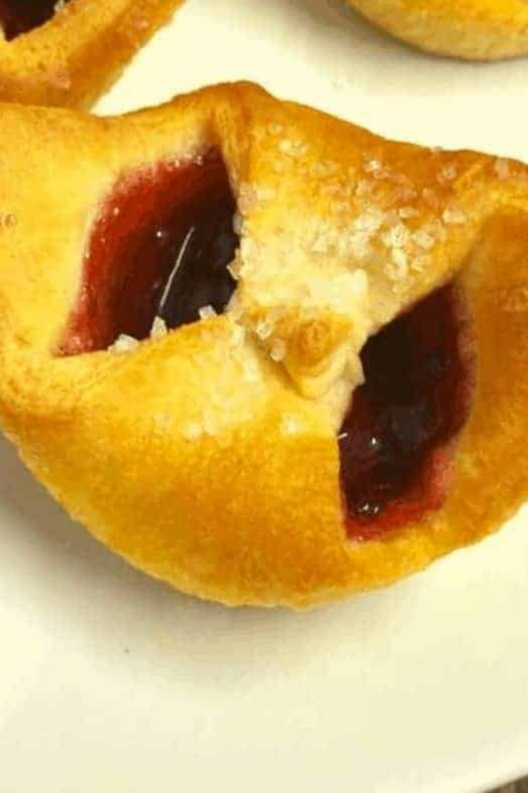 Close-up of air fryer cherry pastries dusted with powdered sugar