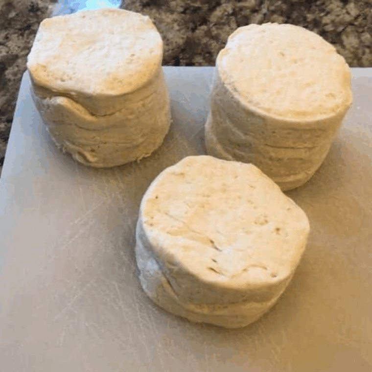 Ingredients for air fryer biscuit donuts: a can of Pillsbury Grands, melted butter, granulated sugar, and ground cinnamon